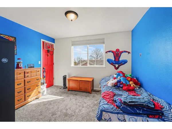 a bed room with a bed and a chair