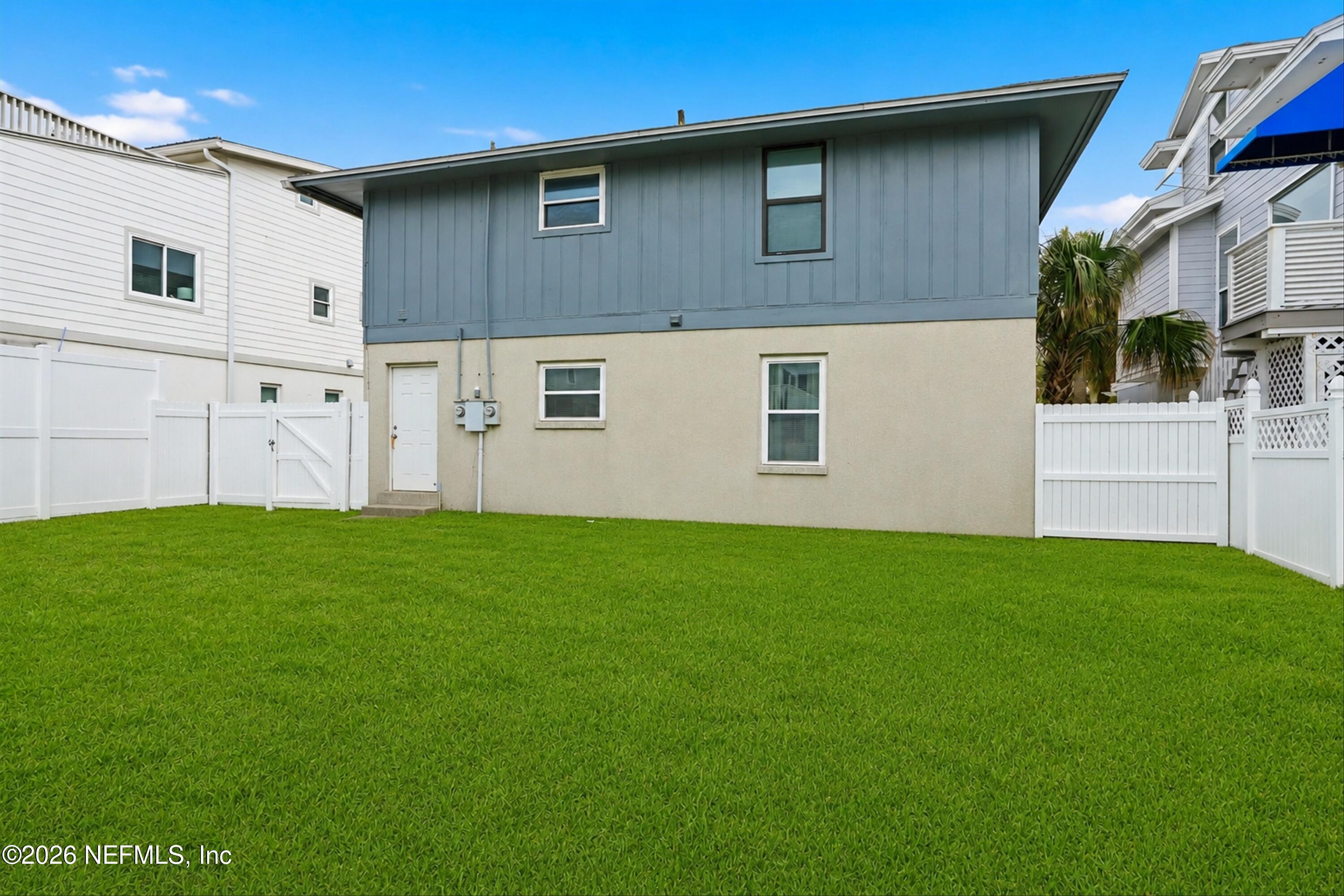 124 Hopkins Street Neptune Beach, FL 32266 - Photo 27 of 44 a backyard of a house with lots of green space