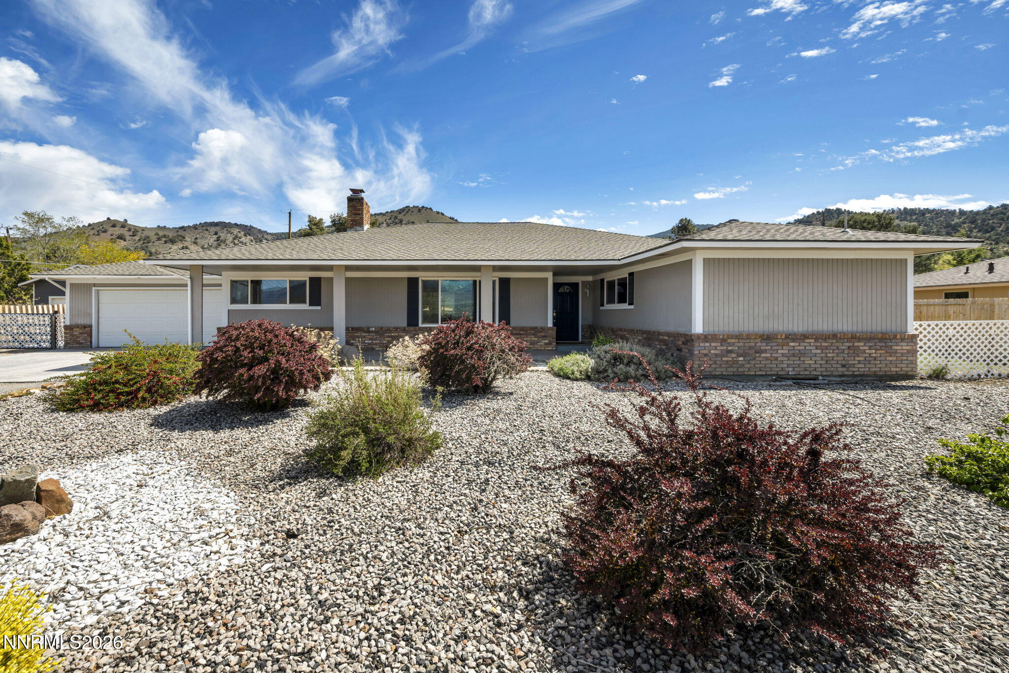 14190 Rim Rock Drive Reno, NV 89521 - Photo 1 of 68 a front view of a house with a garden