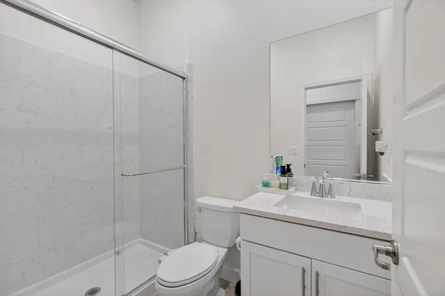 a bathroom with a glass shower door