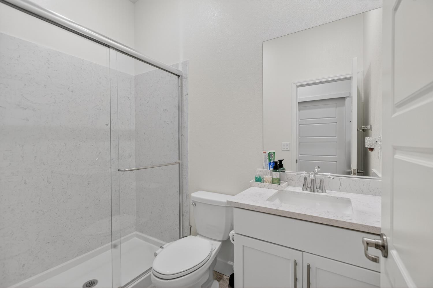 5603 Drifton Way Sacramento, CA 95835 - Photo 13 of 49 a bathroom with a sink a toilet and shower