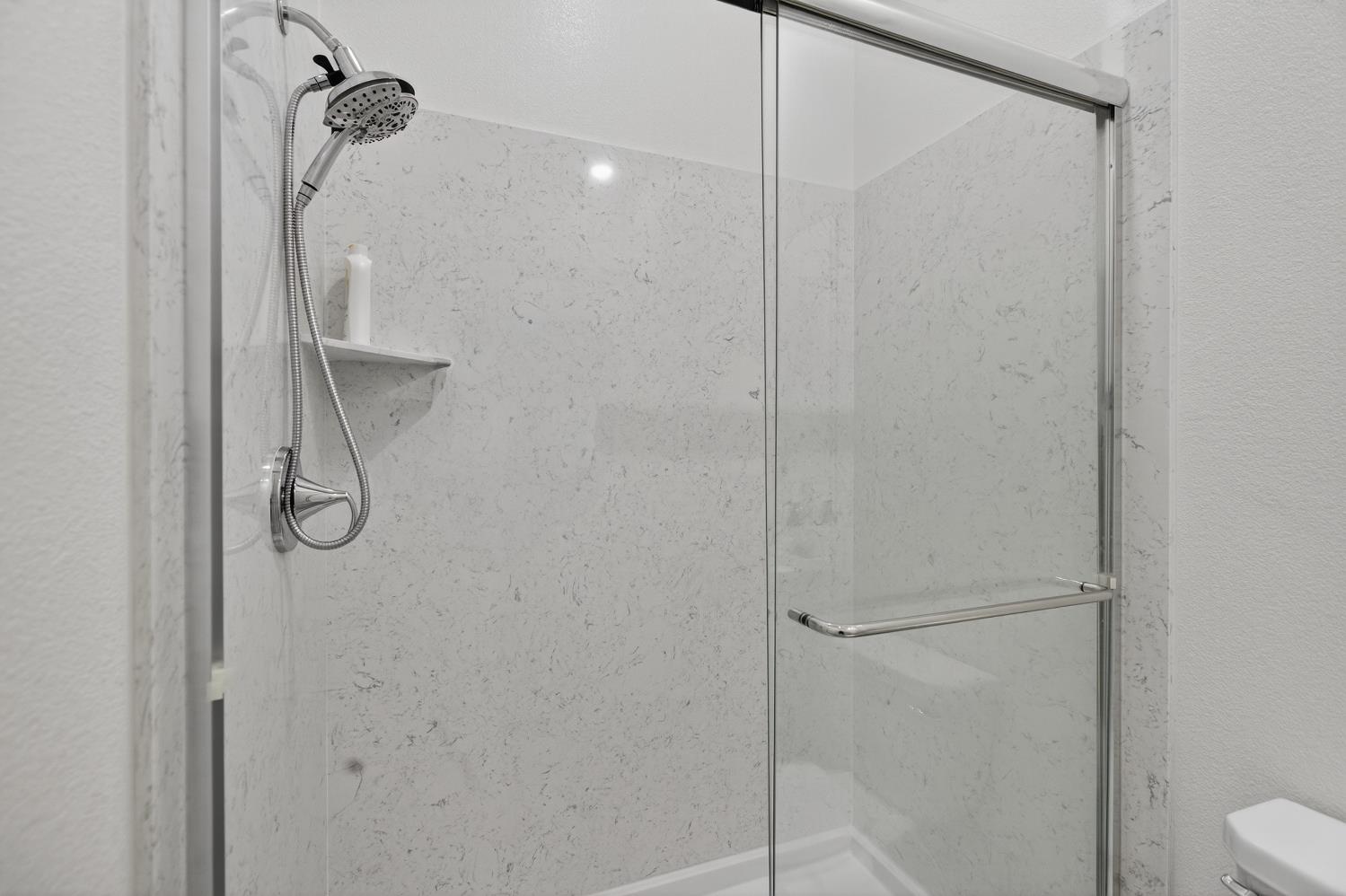 5603 Drifton Way Sacramento, CA 95835 - Photo 14 of 49 a bathroom with a glass shower door