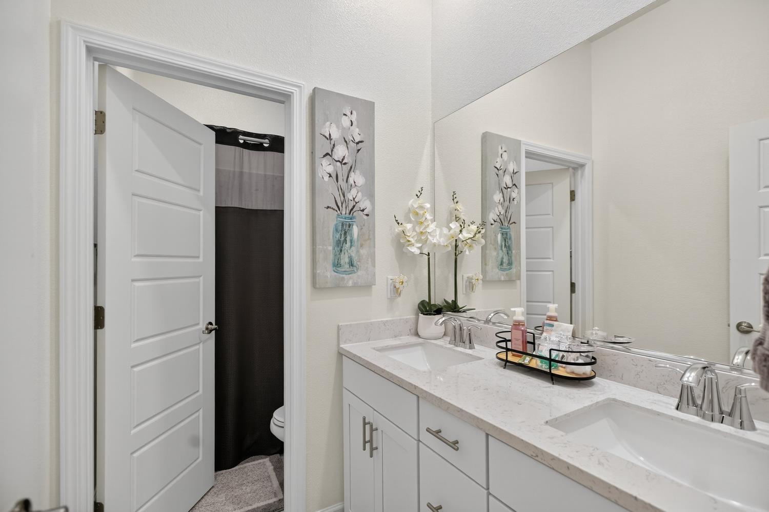 5603 Drifton Way Sacramento, CA 95835 - Photo 17 of 49 a bathroom with double vanity sinks and a mirror