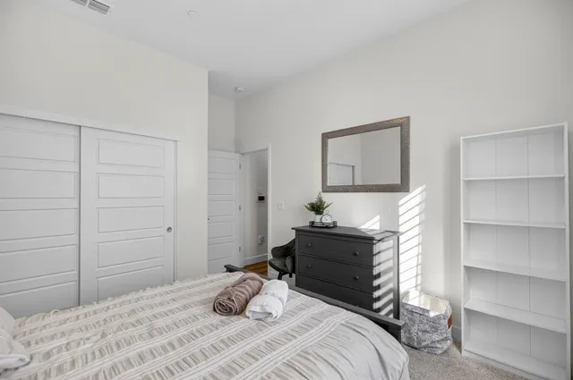 a large kitchen with stainless steel appliances kitchen island granite countertop a large counter top and wooden floors