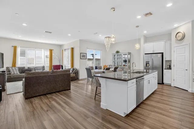 a large kitchen with granite countertop lots of counter space and stainless steel appliances