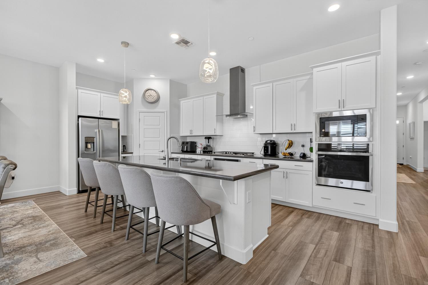 5603 Drifton Way Sacramento, CA 95835 - Photo 24 of 49 a kitchen with stainless steel appliances granite countertop a white cabinets and wooden floor