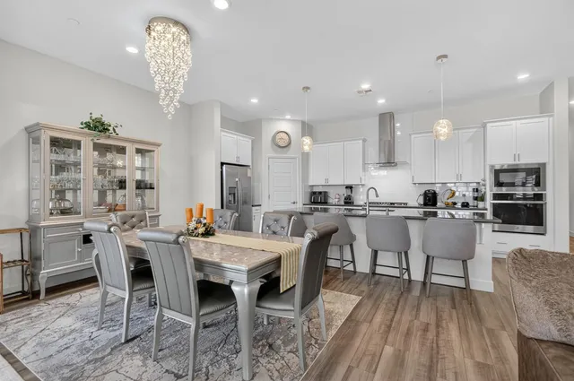a kitchen with white cabinets and appliances