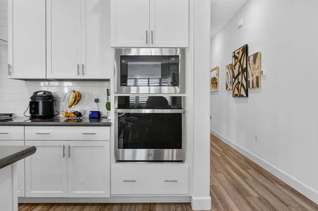 a kitchen with cabinets and steel stainless steel appliances