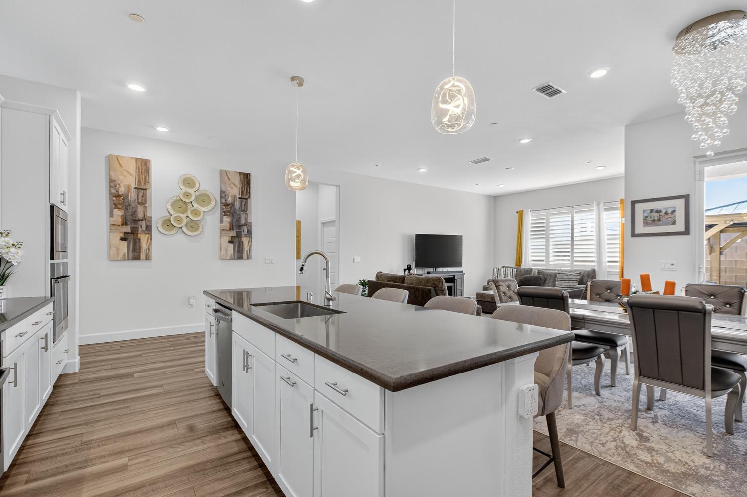 5603 Drifton Way Sacramento, CA 95835 - Photo 28 of 49 a view of a kitchen with kitchen island stainless steel appliances a sink and living room view
