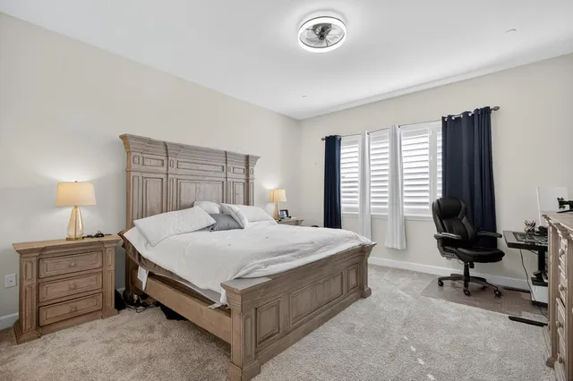 a bedroom with a bed and a lamp on table