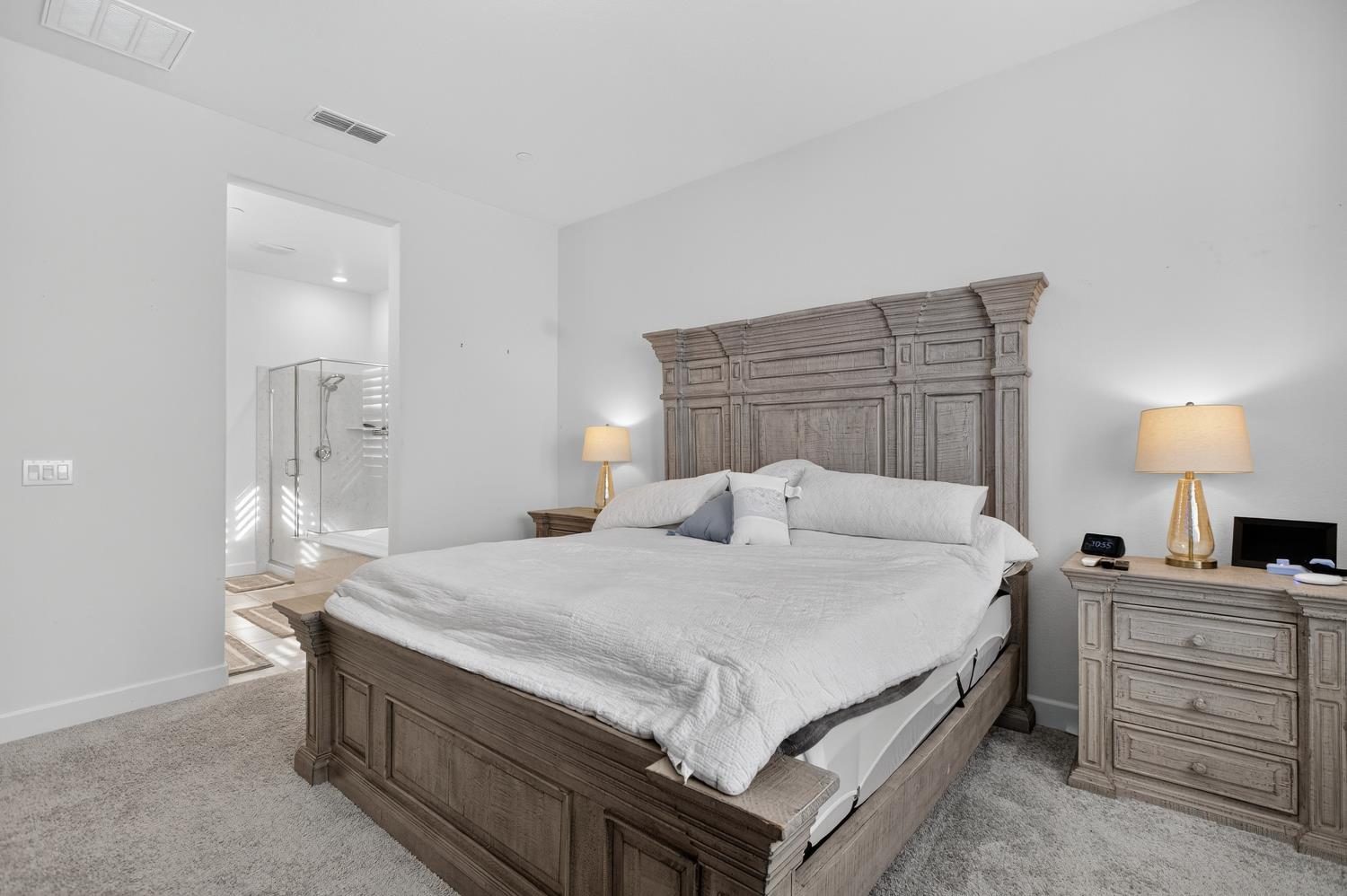 5603 Drifton Way Sacramento, CA 95835 - Photo 34 of 49 a bedroom with a bed and a lamp on table