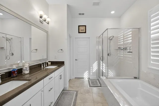 a bathroom with a tub a sink and a shower