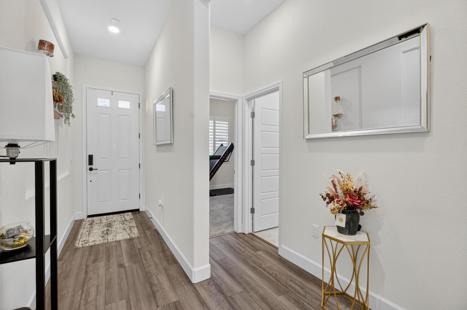 5603 Drifton Way Sacramento, CA 95835 - Photo 5 of 49 a view of a hallway with wooden floor and entryway