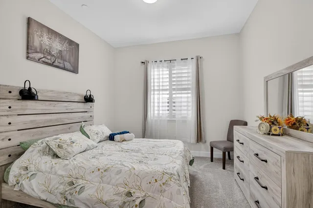 a bedroom with a bed and a chair