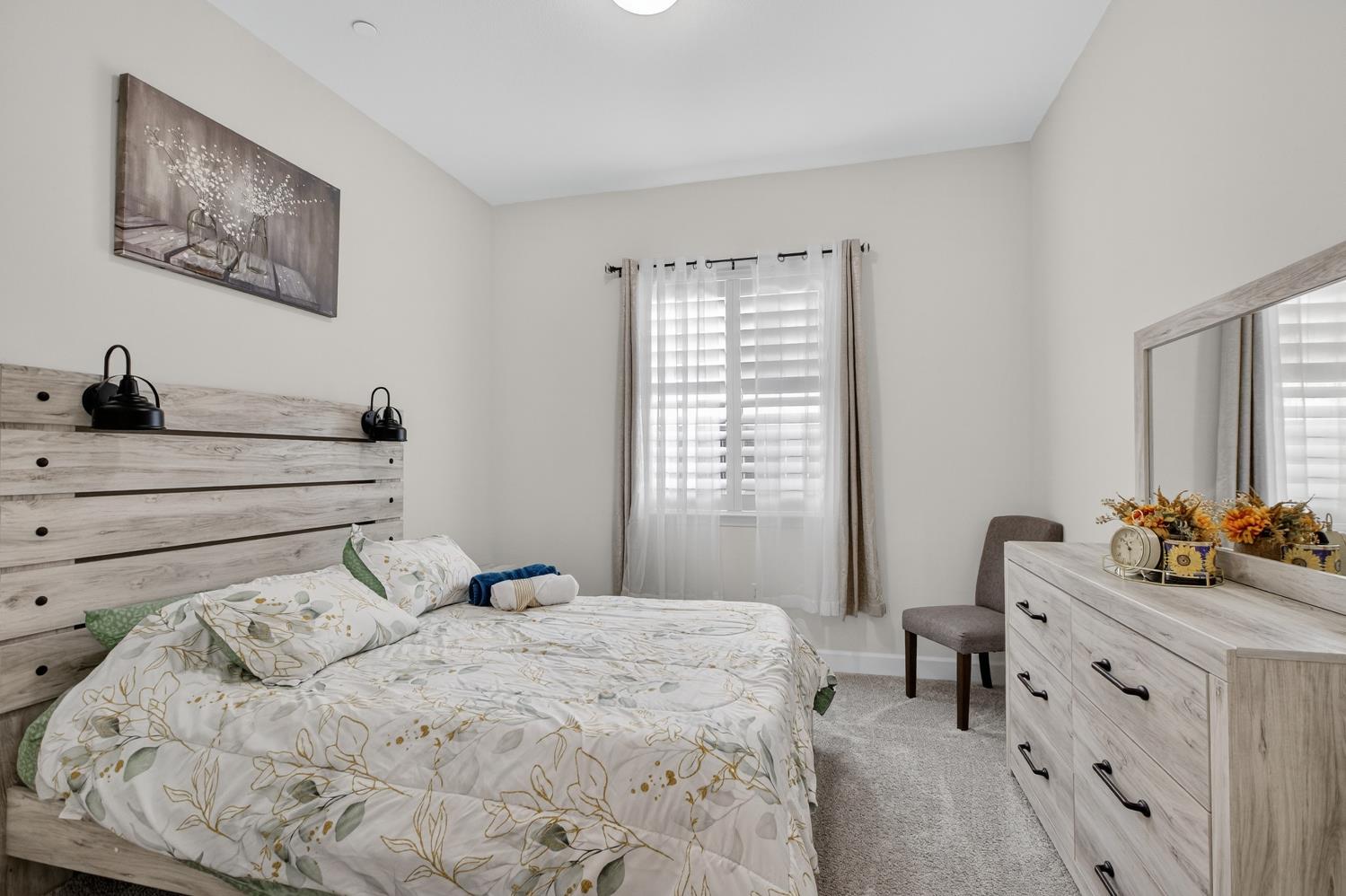 5603 Drifton Way Sacramento, CA 95835 - Photo 10 of 49 a bedroom with a bed and a dresser