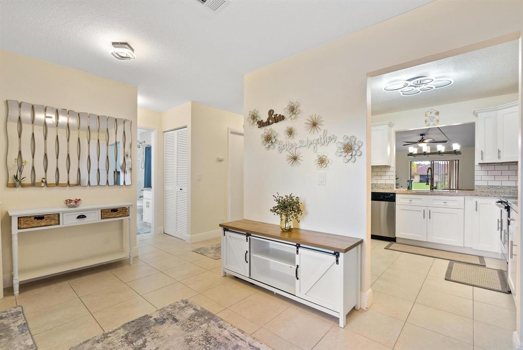6734 Bridlewood Court, Unit 6734 Boca Raton, FL 33433 - Photo 16 of 42 a living room with stainless steel appliances kitchen island granite countertop furniture and a view of living room