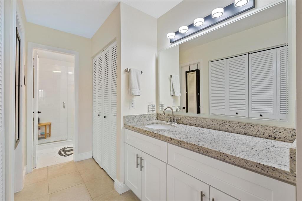 6734 Bridlewood Court, Unit 6734 Boca Raton, FL 33433 - Photo 22 of 42 a bathroom with a granite countertop sink and a mirror
