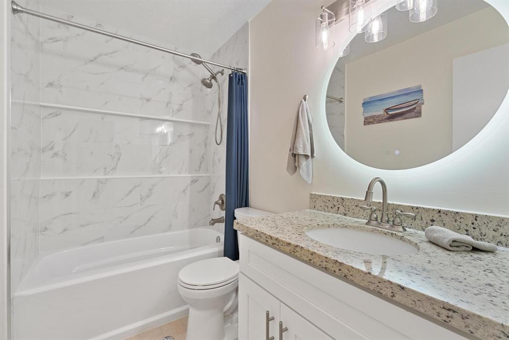 6734 Bridlewood Court, Unit 6734 Boca Raton, FL 33433 - Photo 25 of 42 a bathroom with a granite countertop sink toilet and shower