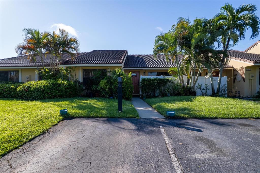 6734 Bridlewood Court, Unit 6734 Boca Raton, FL 33433 - Photo 30 of 42 a view of a house with a yard and potted plants