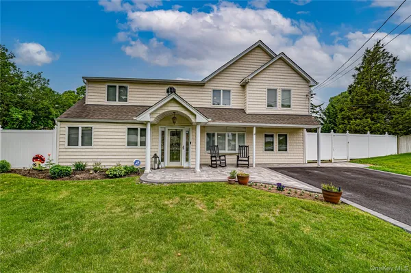 a front view of house with yard and outdoor seating