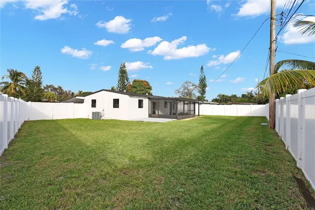 a view of a house with a backyard