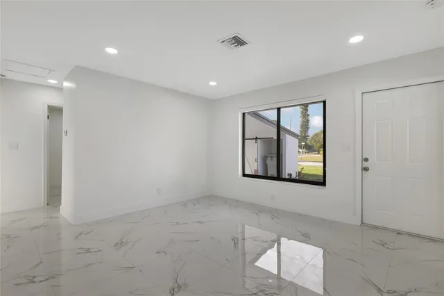 a view of an empty room with a window