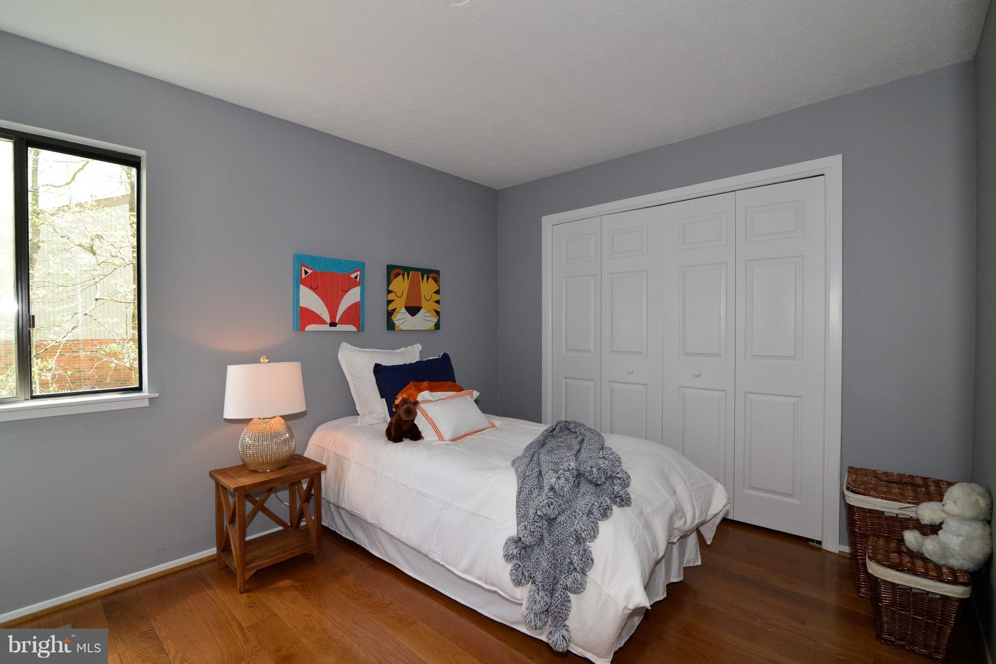 2203 Spinnaker Court Reston, VA 20191 - Photo 21 of 30 a bedroom with a bed and wooden floor