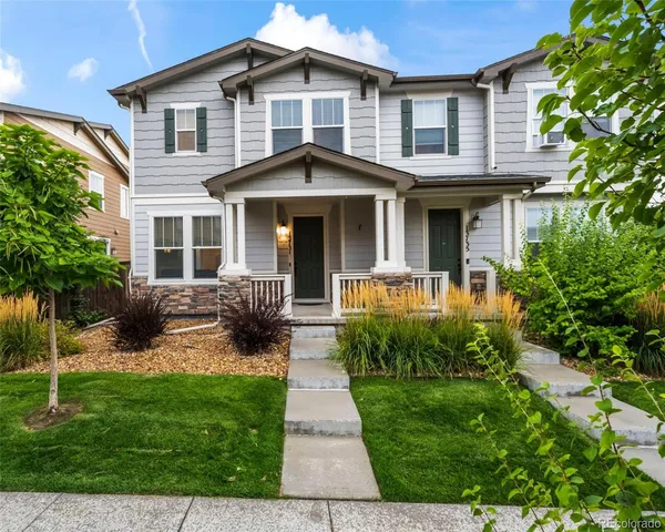 a front view of a house with garden and porch
