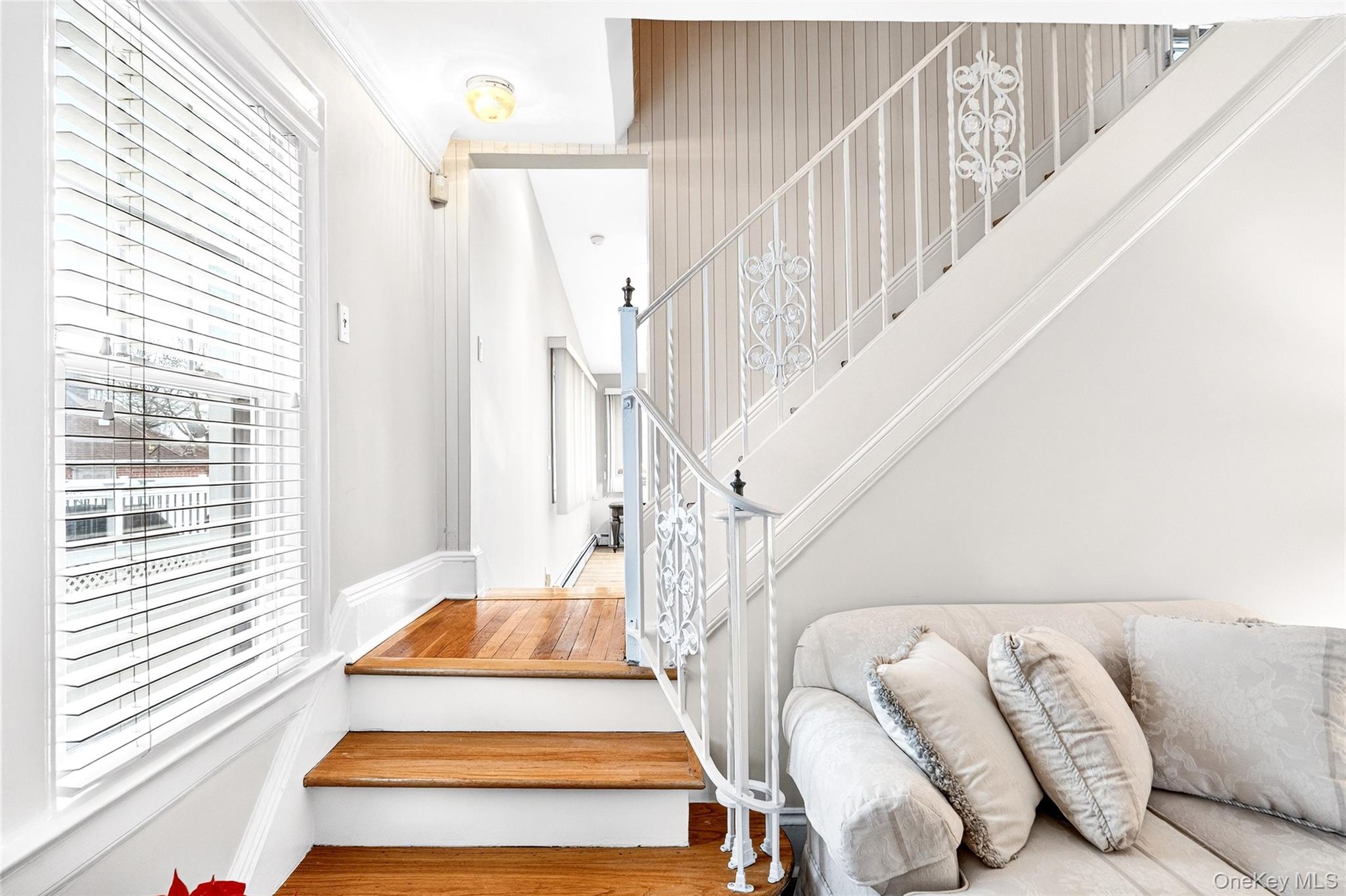 3334 Country Club Road Bronx, NY 10465 - Photo 29 of 49 Staircase featuring plenty of natural light and wood finished floors