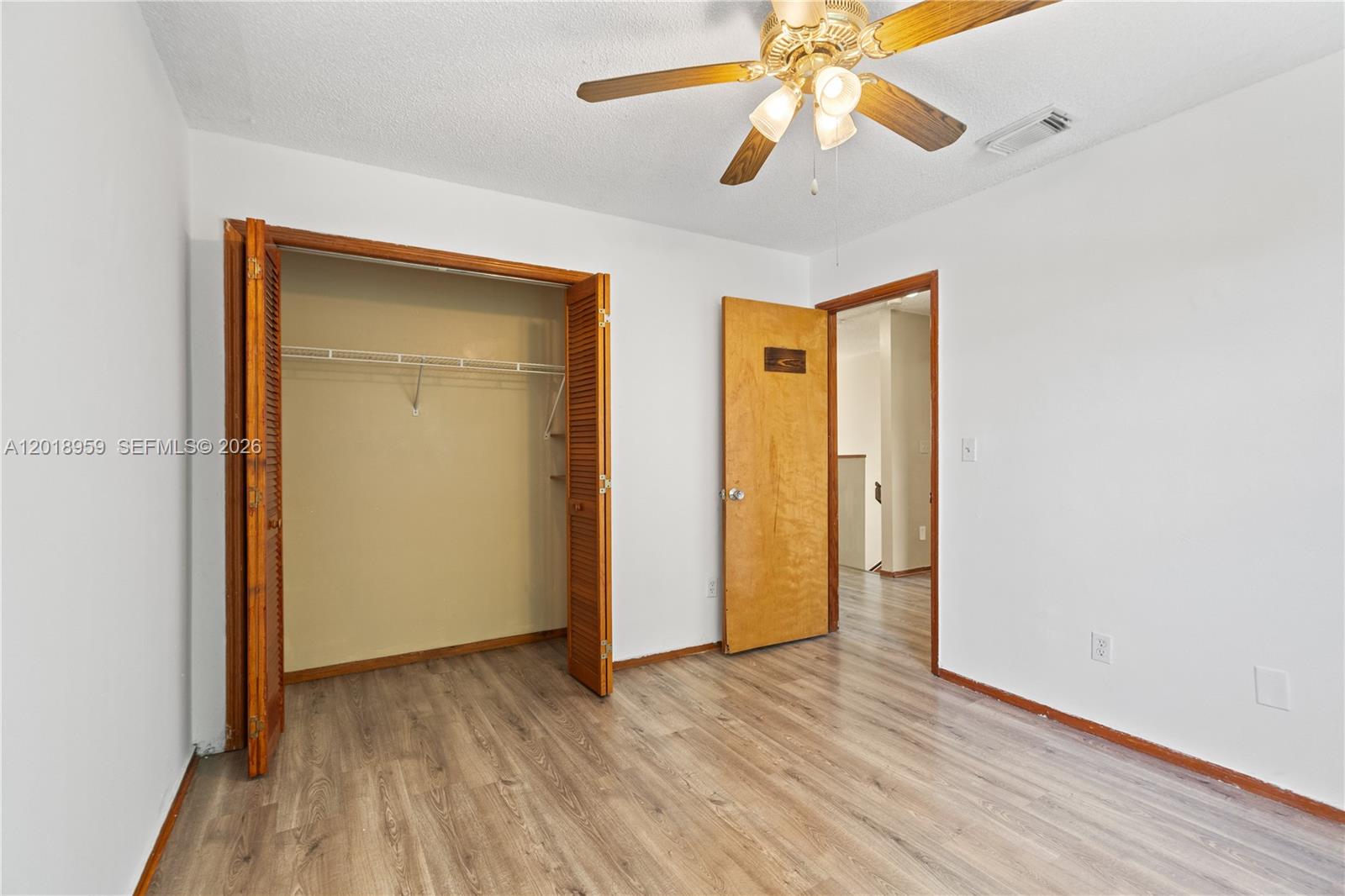 15345 Southwest 63rd Terrace Miami, FL 33193 - Photo 20 of 51 an empty room with wooden floor closet fan and windows
