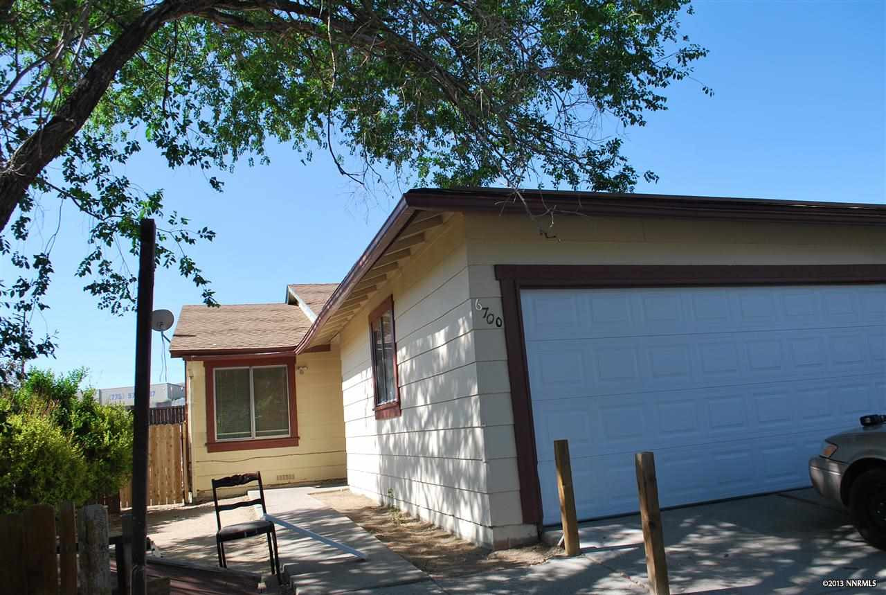 a front view of a house with parking area