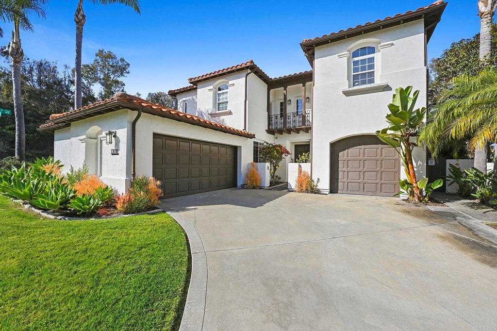 1304 Corvidae Street Carlsbad, CA 92011 - Photo 1 of 1 a front view of a house with a garden and plants