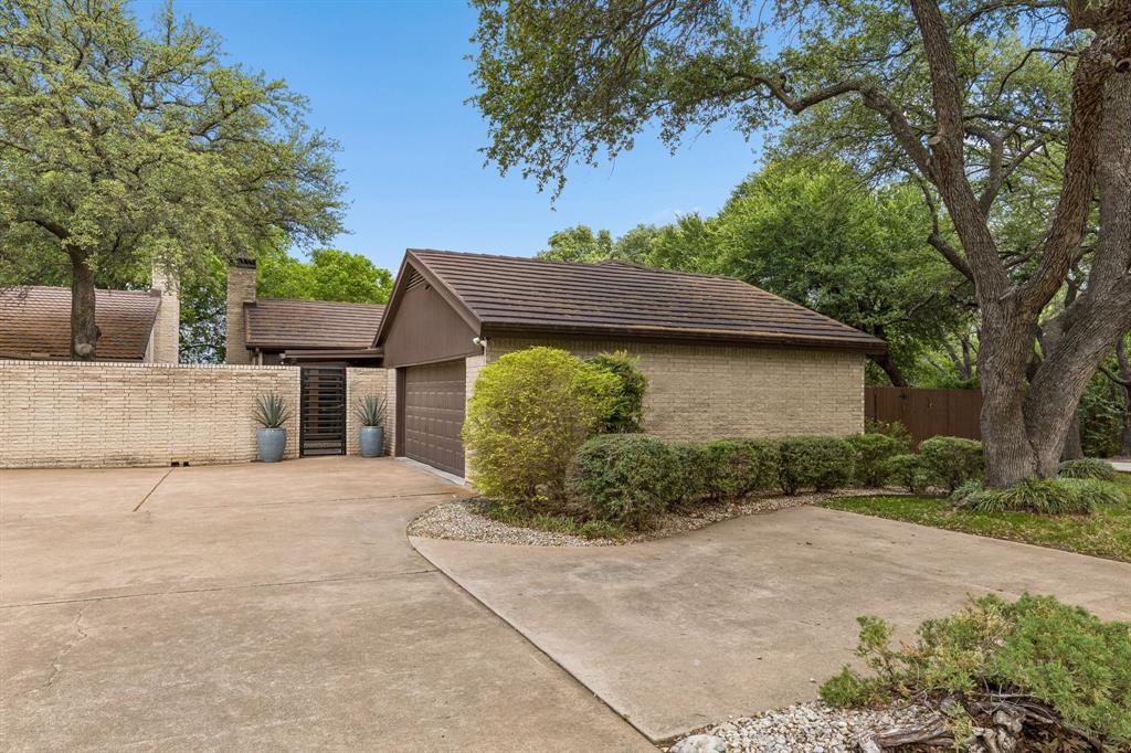 a view of a house with a tree in front of it