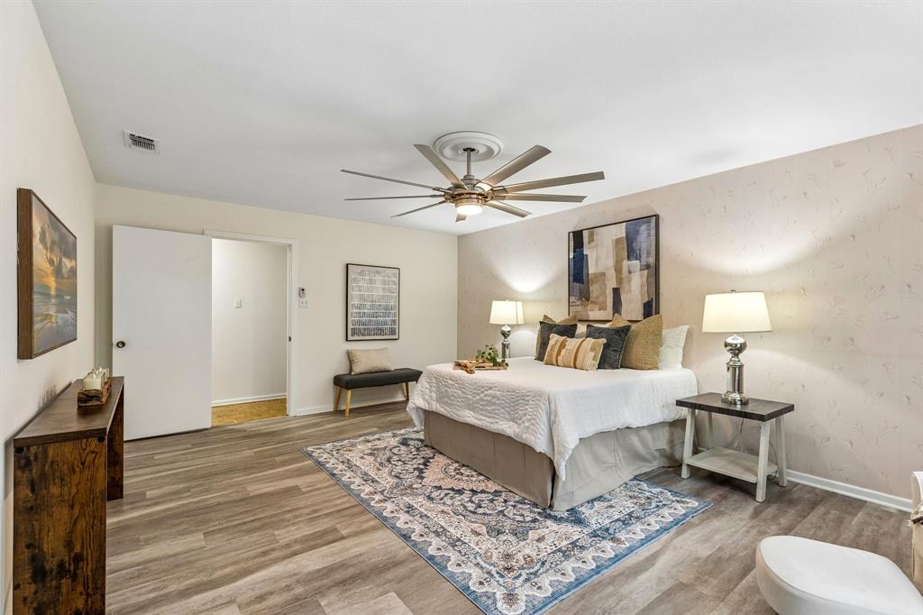 24 Legend Road Benbrook, TX 76132 - Photo 14 of 28 a bedroom with a bed and wooden floor