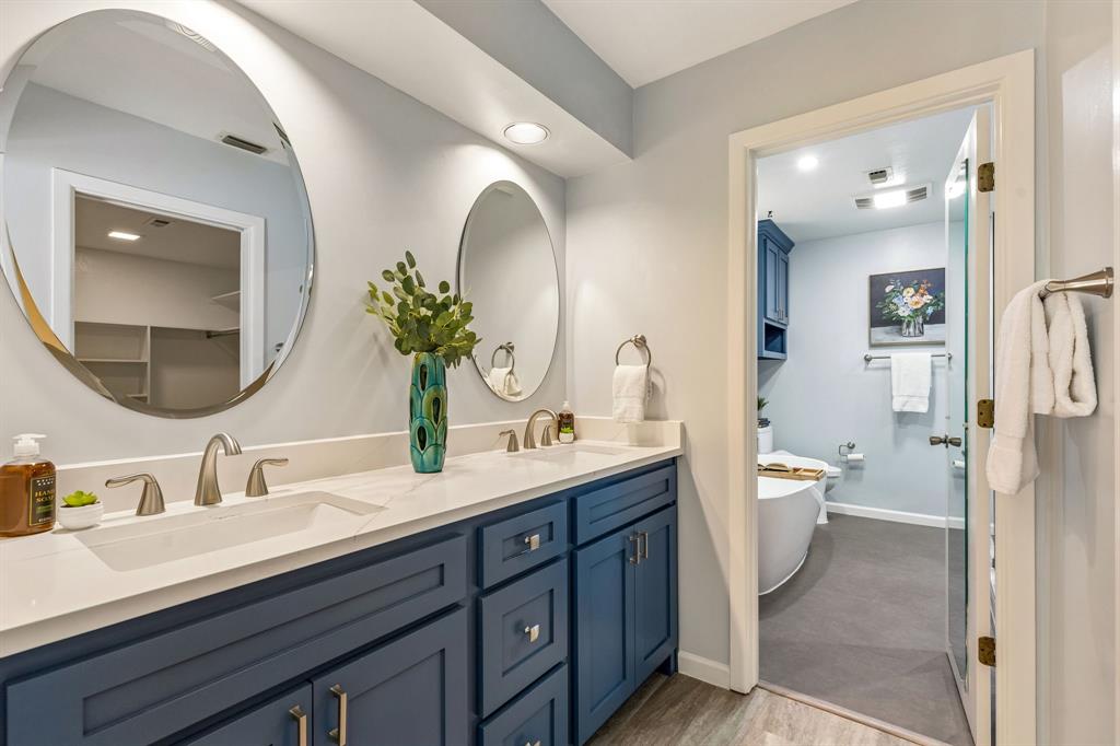 24 Legend Road Benbrook, TX 76132 - Photo 15 of 28 a spacious bathroom with a double vanity sink a large mirror and a toilet