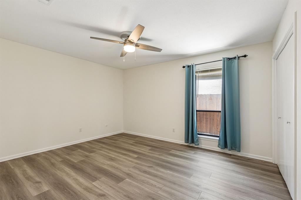 24 Legend Road Benbrook, TX 76132 - Photo 22 of 28 an empty room with wooden floor fan and windows
