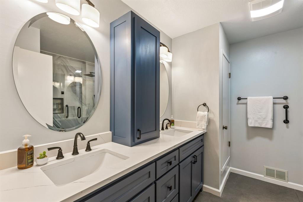 24 Legend Road Benbrook, TX 76132 - Photo 23 of 28 a bathroom with a double vanity sink and a mirror