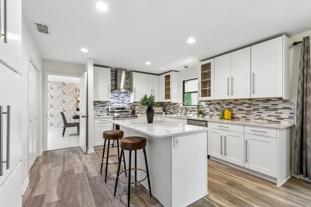 24 Legend Road Benbrook, TX 76132 - Photo 8 of 28 a kitchen with stainless steel appliances kitchen island granite countertop a stove and white cabinets
