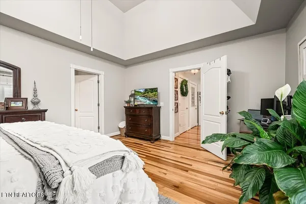 a bedroom with a bed and a potted plant