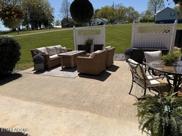 a front view of house with yard and trees in the background