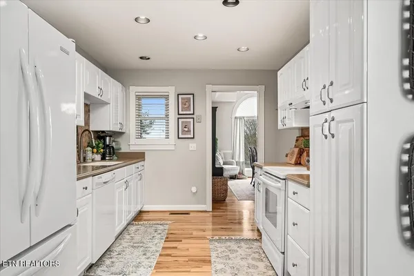 a view of a kitchen with a sink and refrigerator