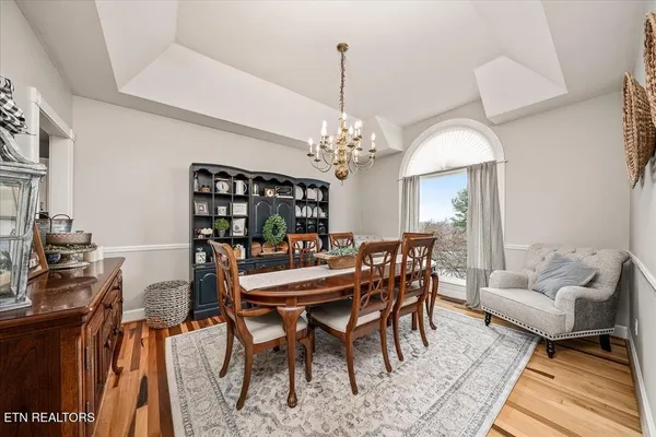 a view of a dining room with furniture and chandelier