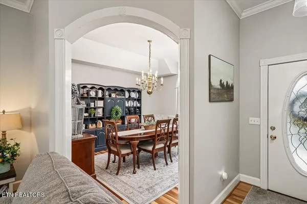 a view of a dining room with furniture and chandelier