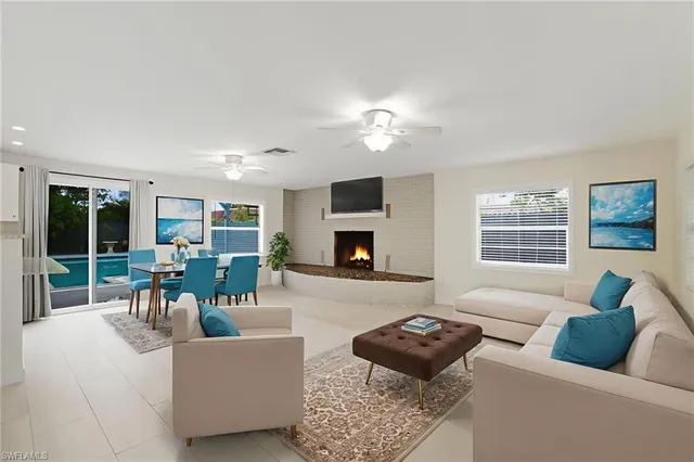 a living room with furniture a fireplace and a flat screen tv