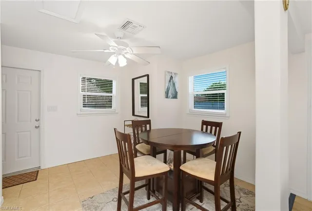 a dining room with furniture and window