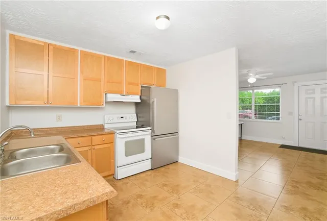 a kitchen with a sink cabinets and appliances