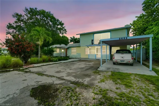 a view of a car parked in front of a house