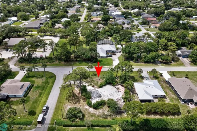 an aerial view of a house with a yard swimming pool and outdoor seating