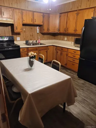 a kitchen with a table chairs and a refrigerator