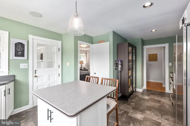 a kitchen that has a table and chairs in it